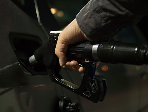 Person fuelling car at petrol station